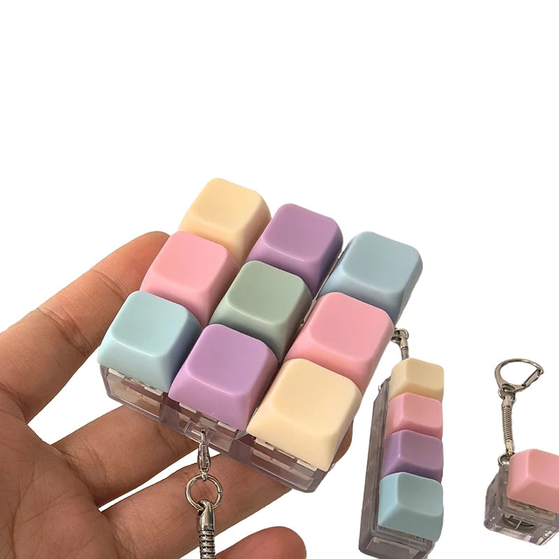Hand holding a pastel fidget keychain
