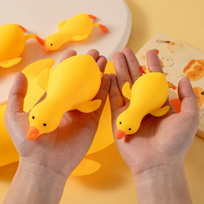 Hands holding yellow squishy ducks